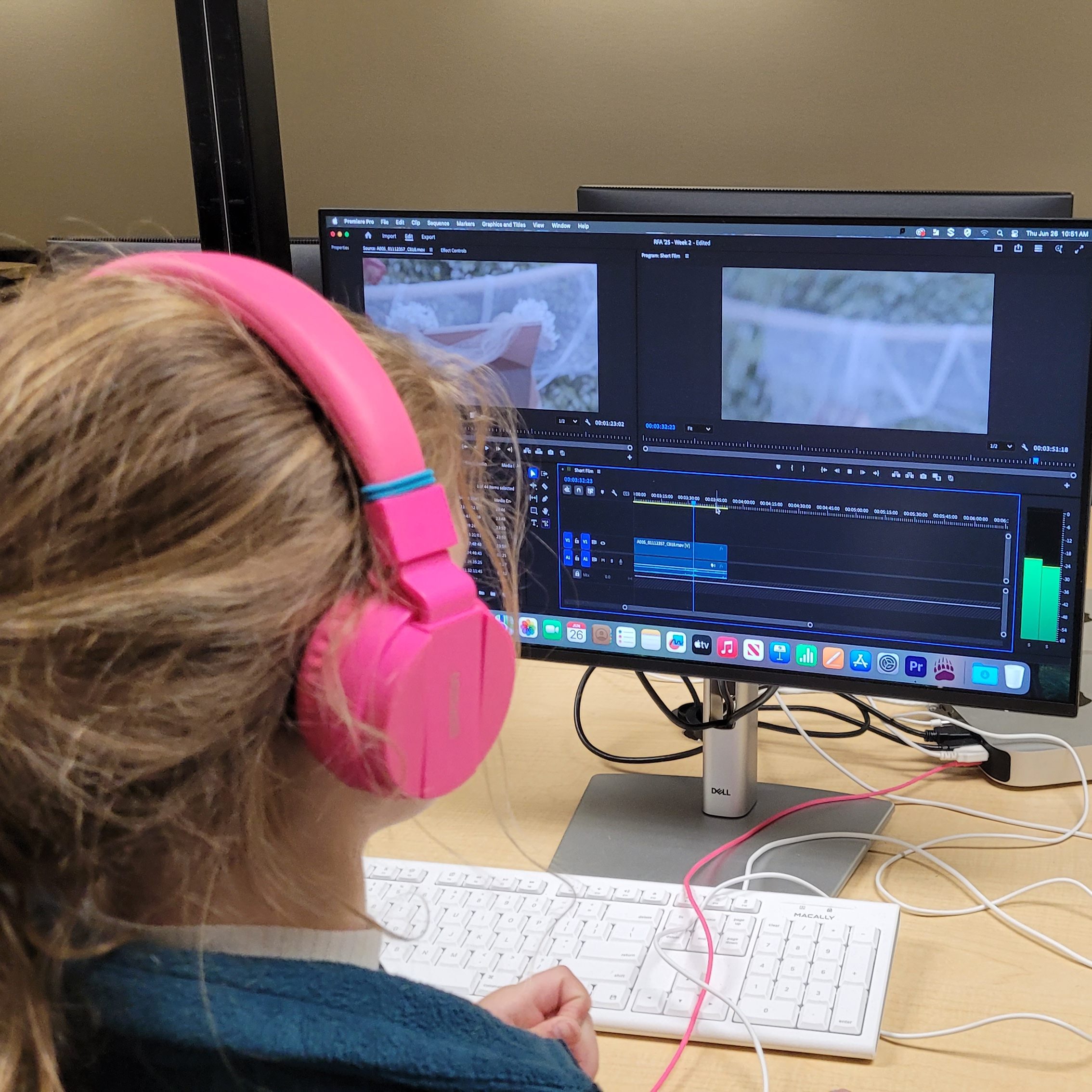 Kid editing film on computer.