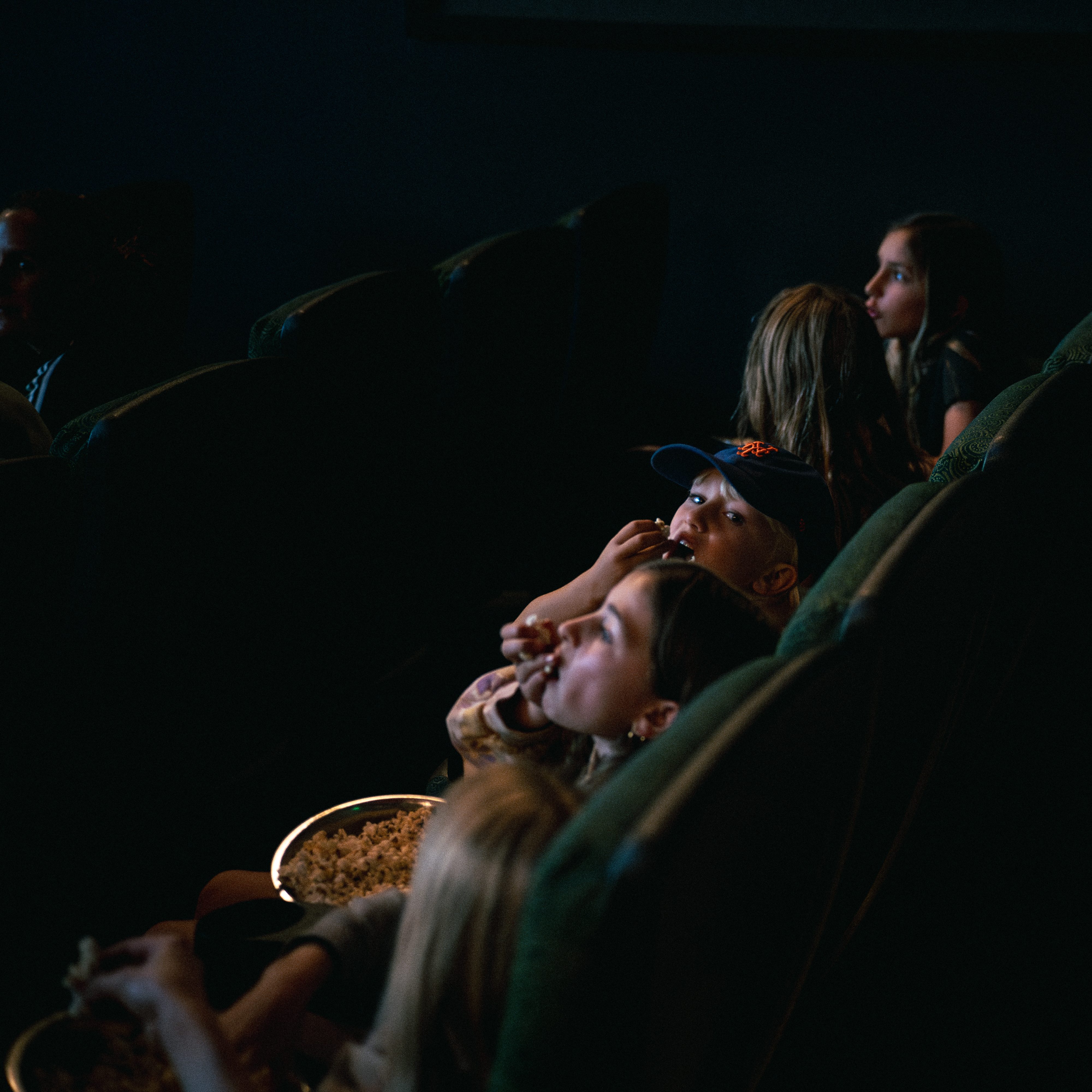 Kids sitting in the movie theater.